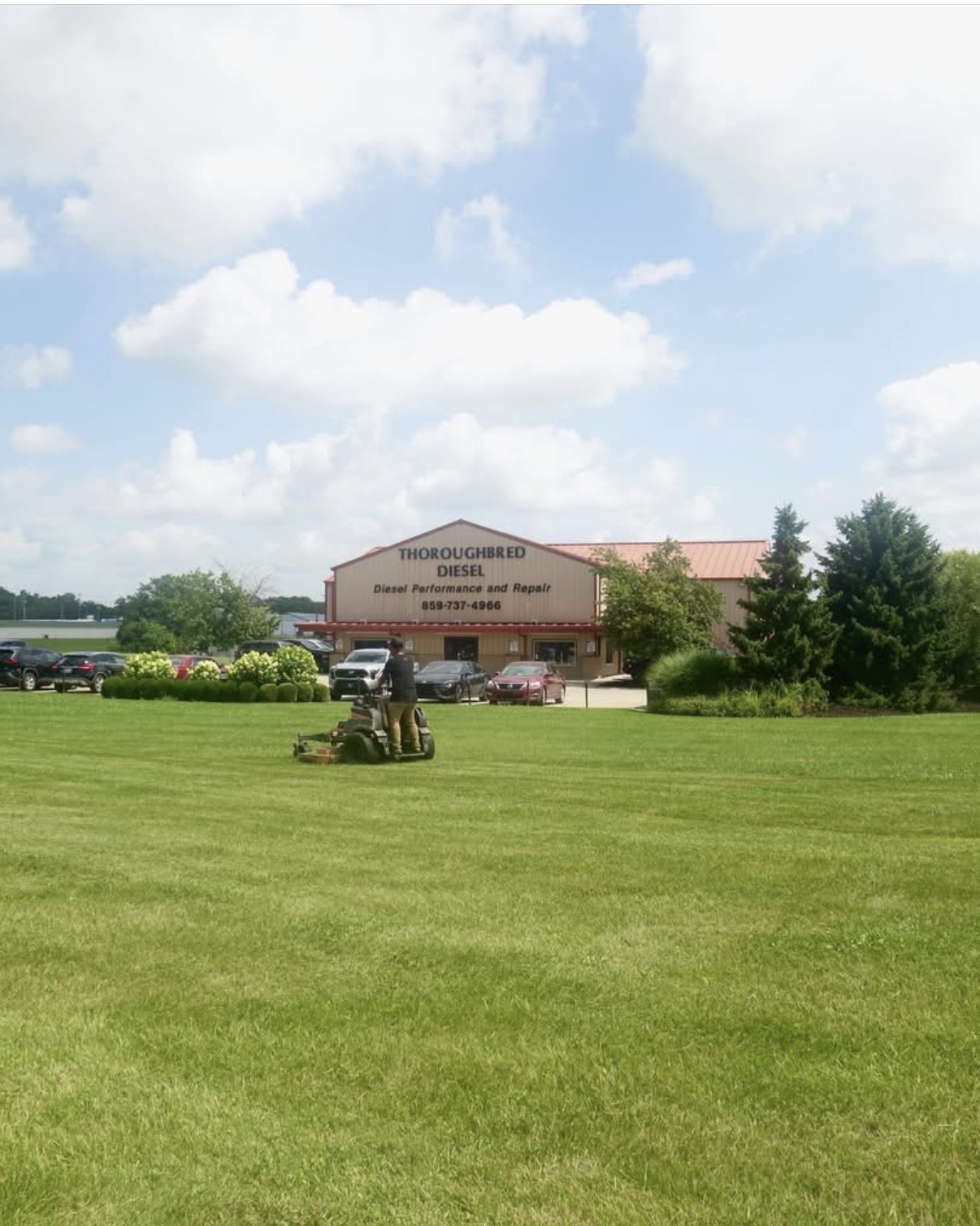 Elite Cuts mowing the lawn outside Thoroughbred Diesel, a commercial property