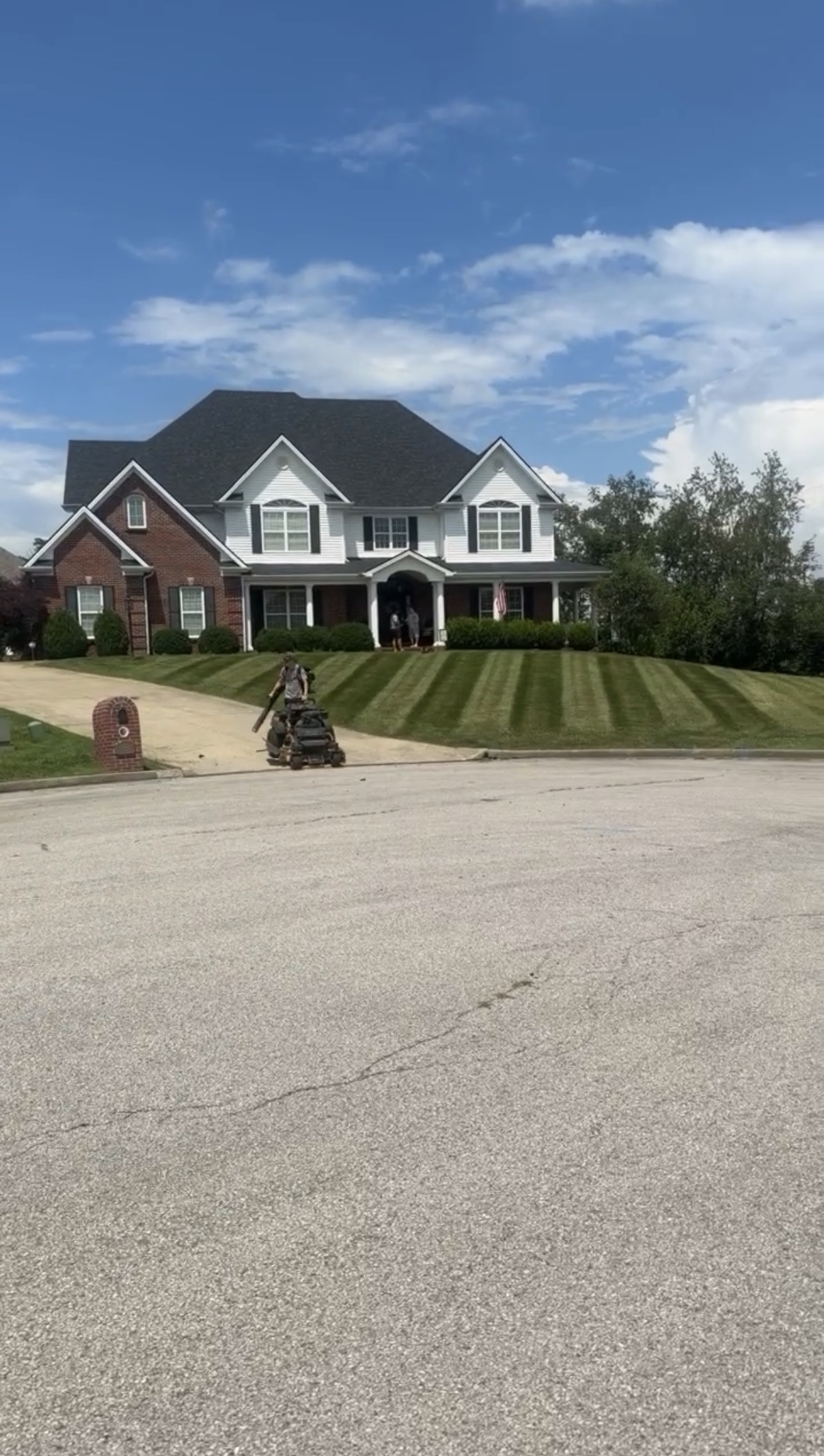 Striped residential lawn mowed by Elite Cuts