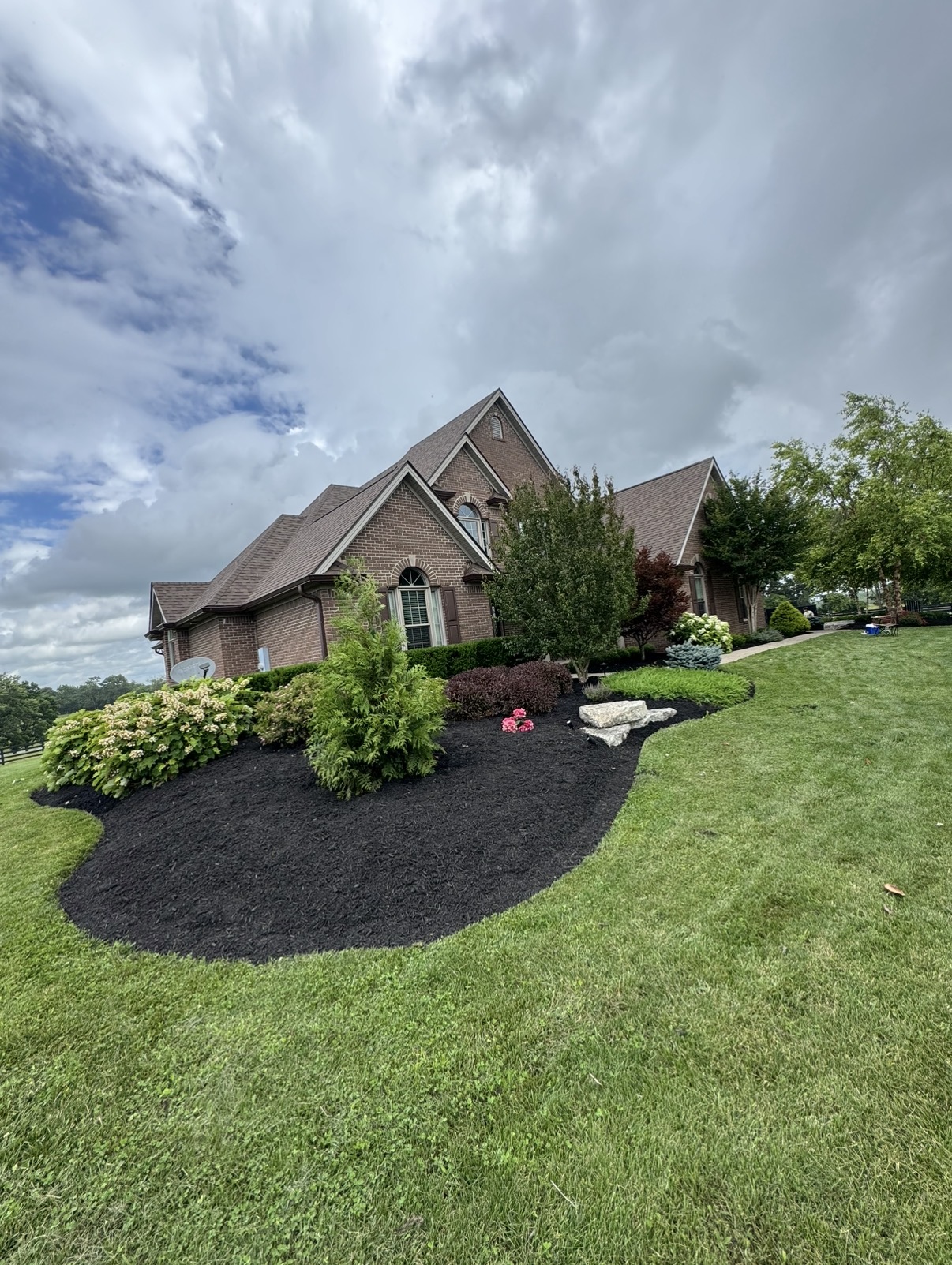 Fresh mulch and landscape beds completed by Elite Cuts